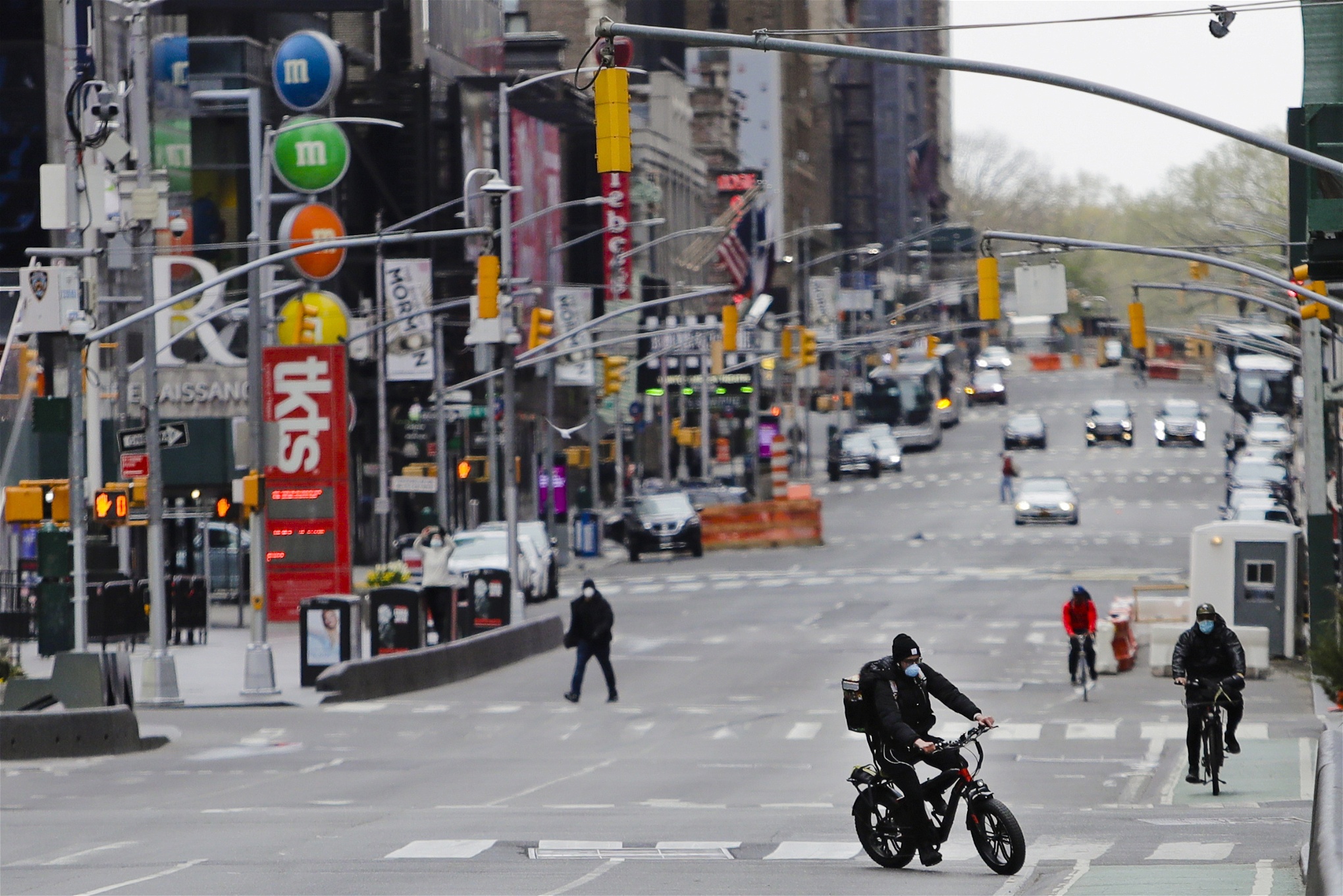 Photo: Frank Franklin II/TTPedestrians and cyclists move through Times Square Friday, April 17, 2020, in New York. New York City streets are largely empty as people continue to stay at home to prevent the spread of COVID-19. 