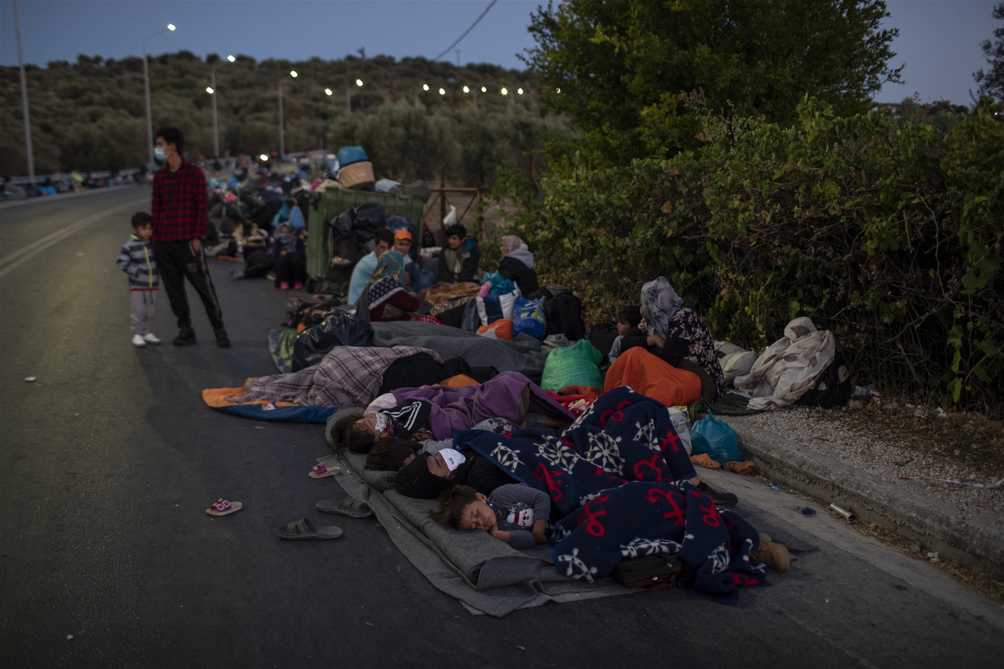 Migranter sover på vägen nära Moria flyktingläger på ön den grekiska ön Lesbos. Foto: Petros Giannakouris/TT