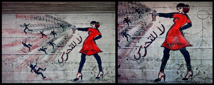 Väggmålning med kvinna i rött som sprayar med en sprayburk.
