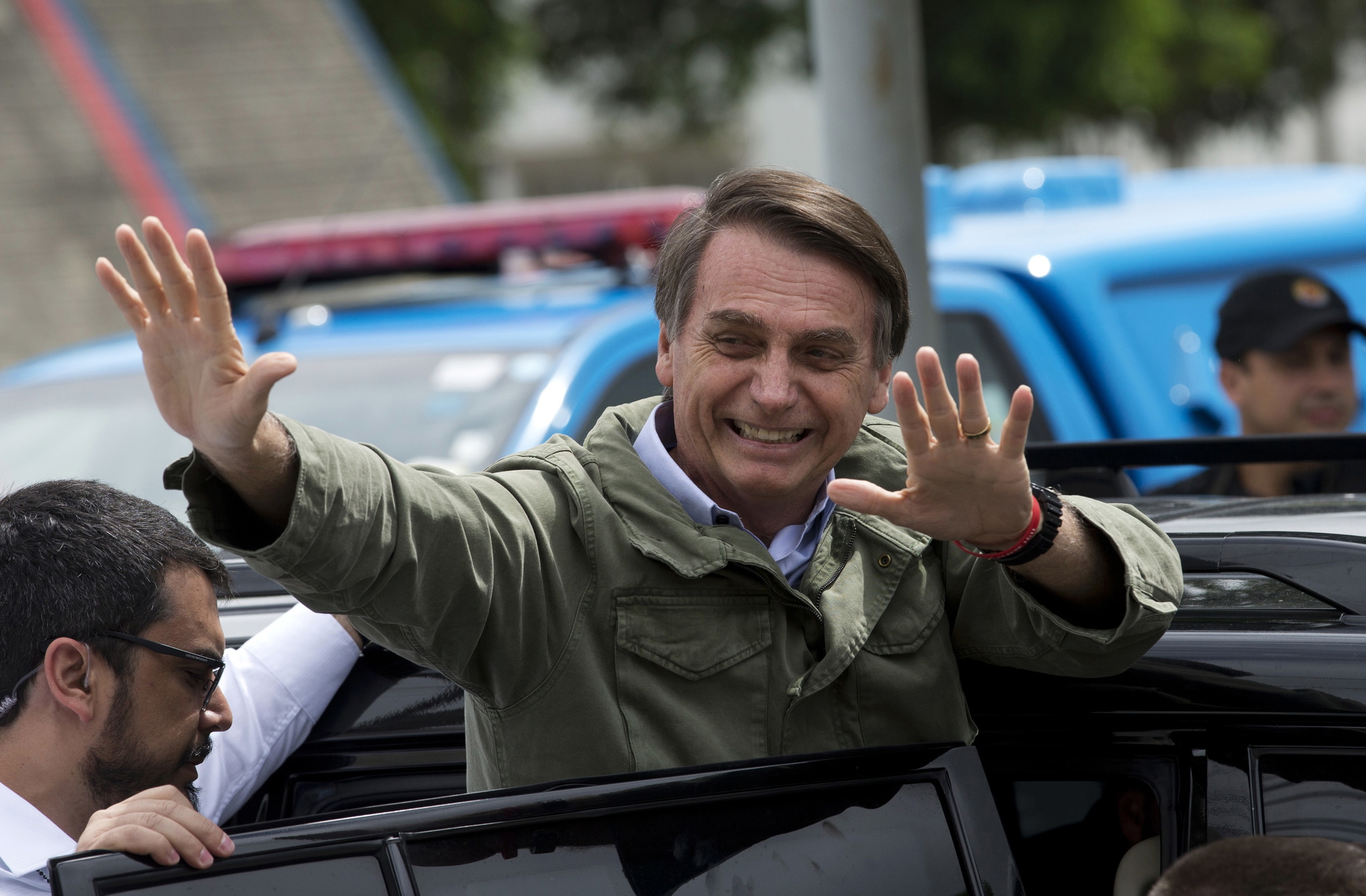 Jair Bolsonaro vinkar och kliver ur en bil.